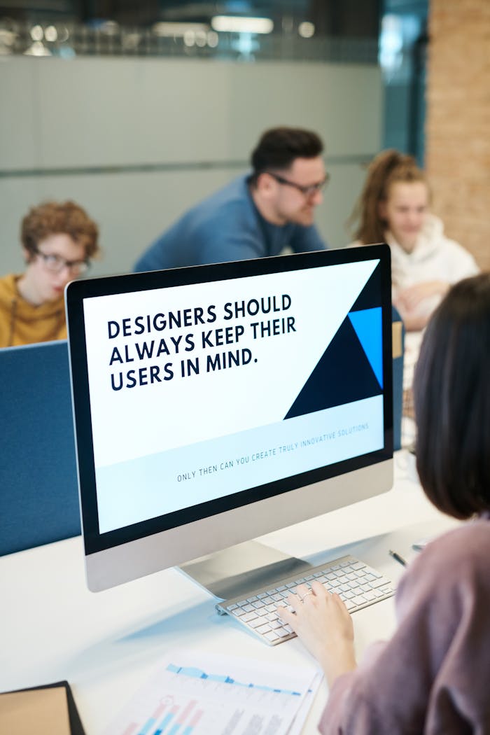 Mastering the First Impression: Your intriguing post title goes here Group of designers collaborating in modern office space with computer.